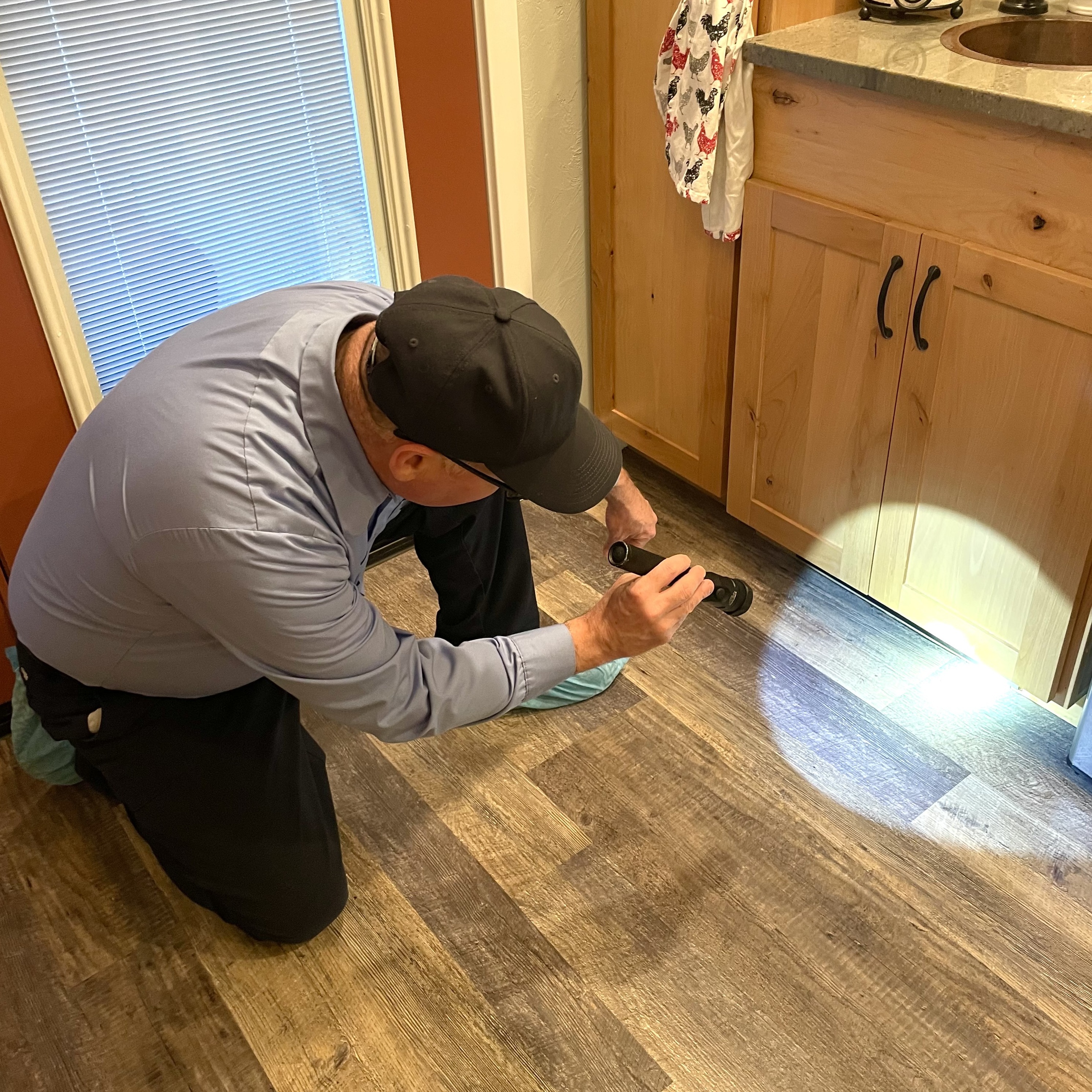 Lonnie performing a pest inspection inside a house